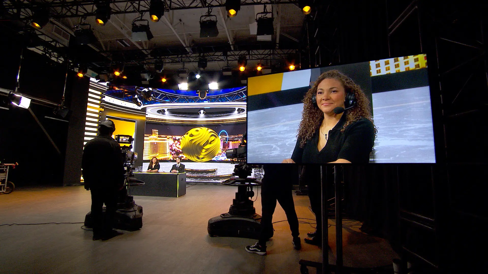 Sports broadcast set with hosts and on-air monitor